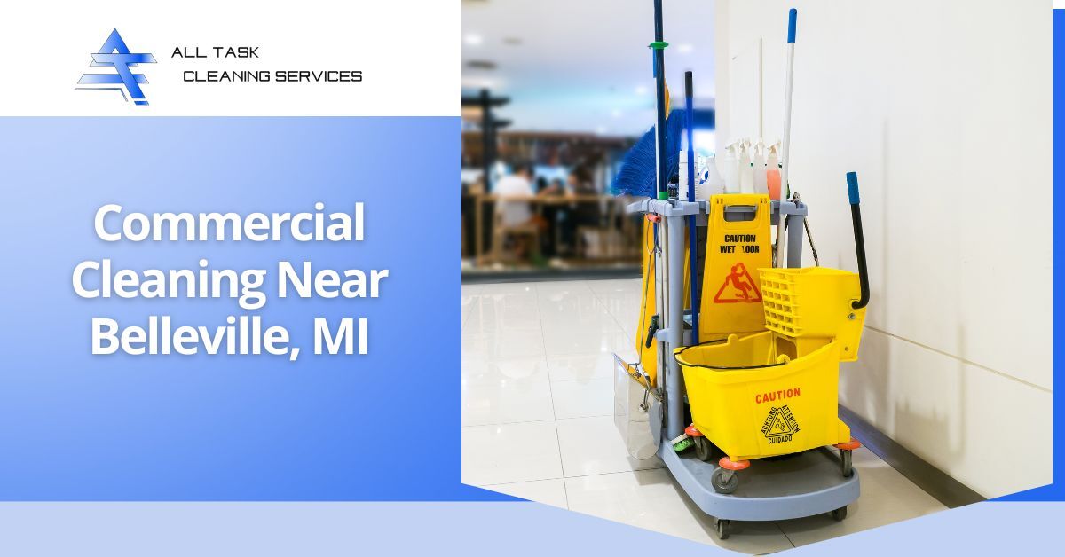 A promotional image for All Task Cleaning Services featuring a yellow cleaning cart equipped with a mop bucket, wringer, caution wet floor signs, and various cleaning tools such as mops and brooms. The cart is positioned in a clean, polished indoor commercial space with blurred background elements suggesting a public area. Overlaid text on the left side reads