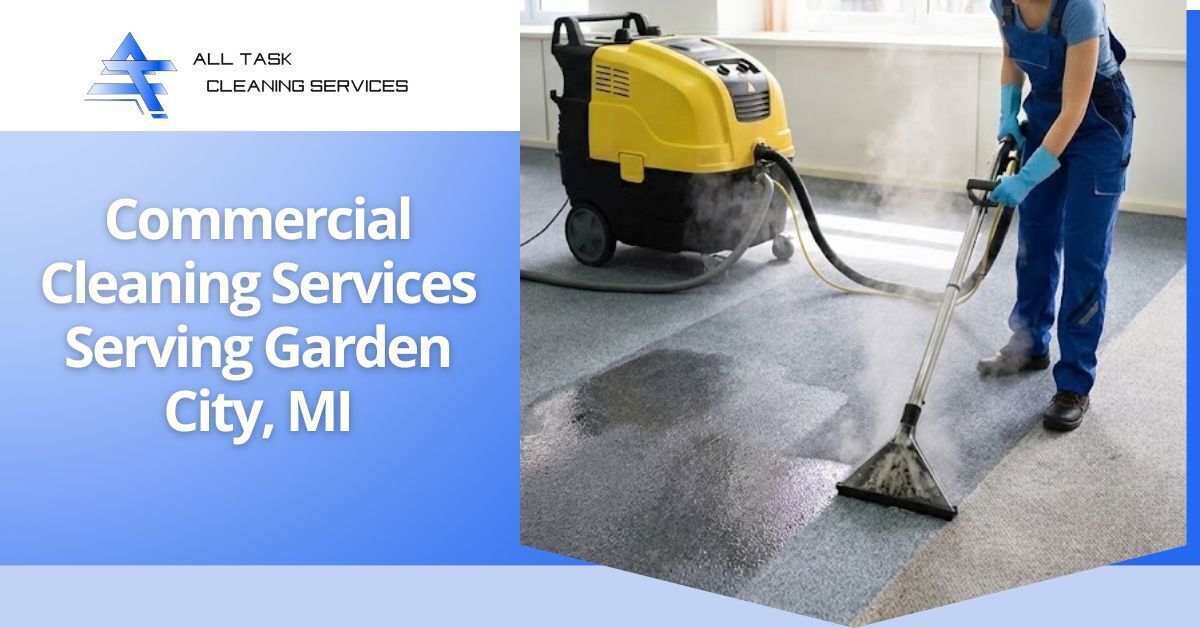 A promotional image for All Task Cleaning Services featuring a professional cleaner in blue overalls and gloves using a yellow and black steam cleaning machine to deep clean a carpeted floor. The cleaner is extracting dirt, leaving a visible clean patch with steam rising. Overlaid on the left side is the company logo and text in white on a blue background: